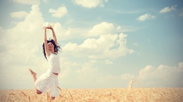 Happy-woman-jumping-in-wheat