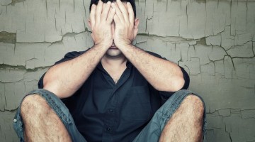 Depressed-young-man-sitting